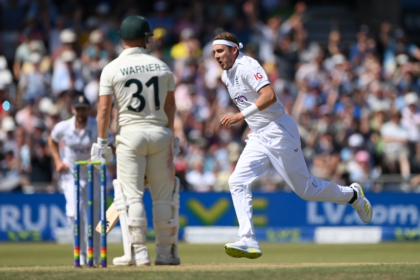 Stuart Broad runs off to celebrate as David Warner stands and watches
