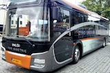 A black, grey and orange electric bus with 'zero emission' written on the side