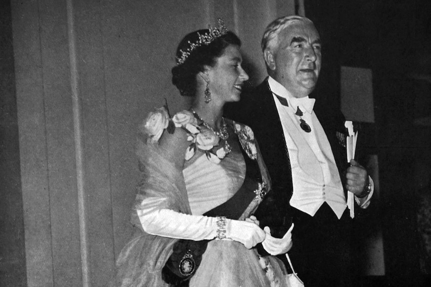 A black and white photo of Queen Elizabeth II and Robert Menzies dressed in a ball gown and suit.