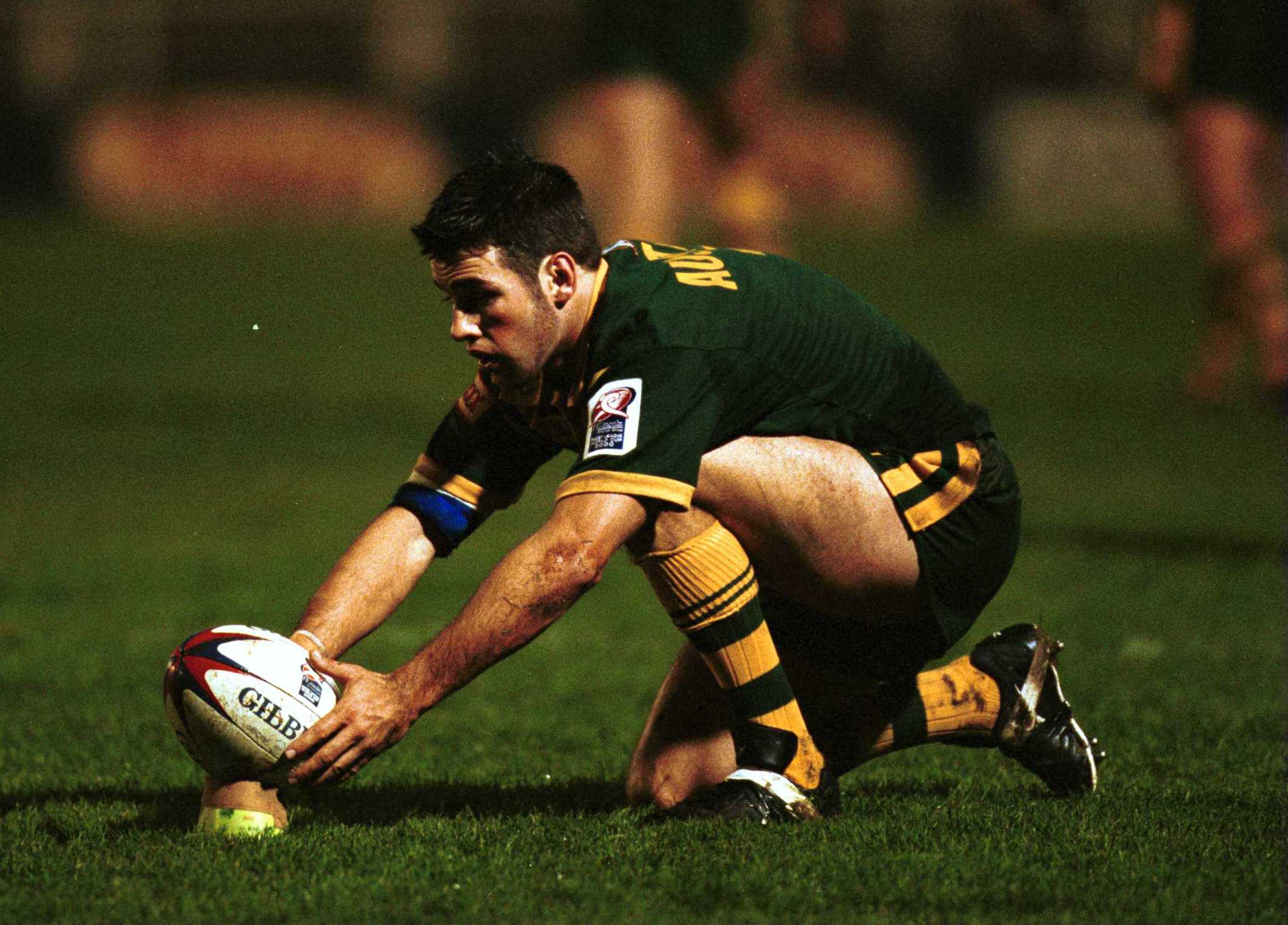 A man lines up a conversion attempt during a rugby league match