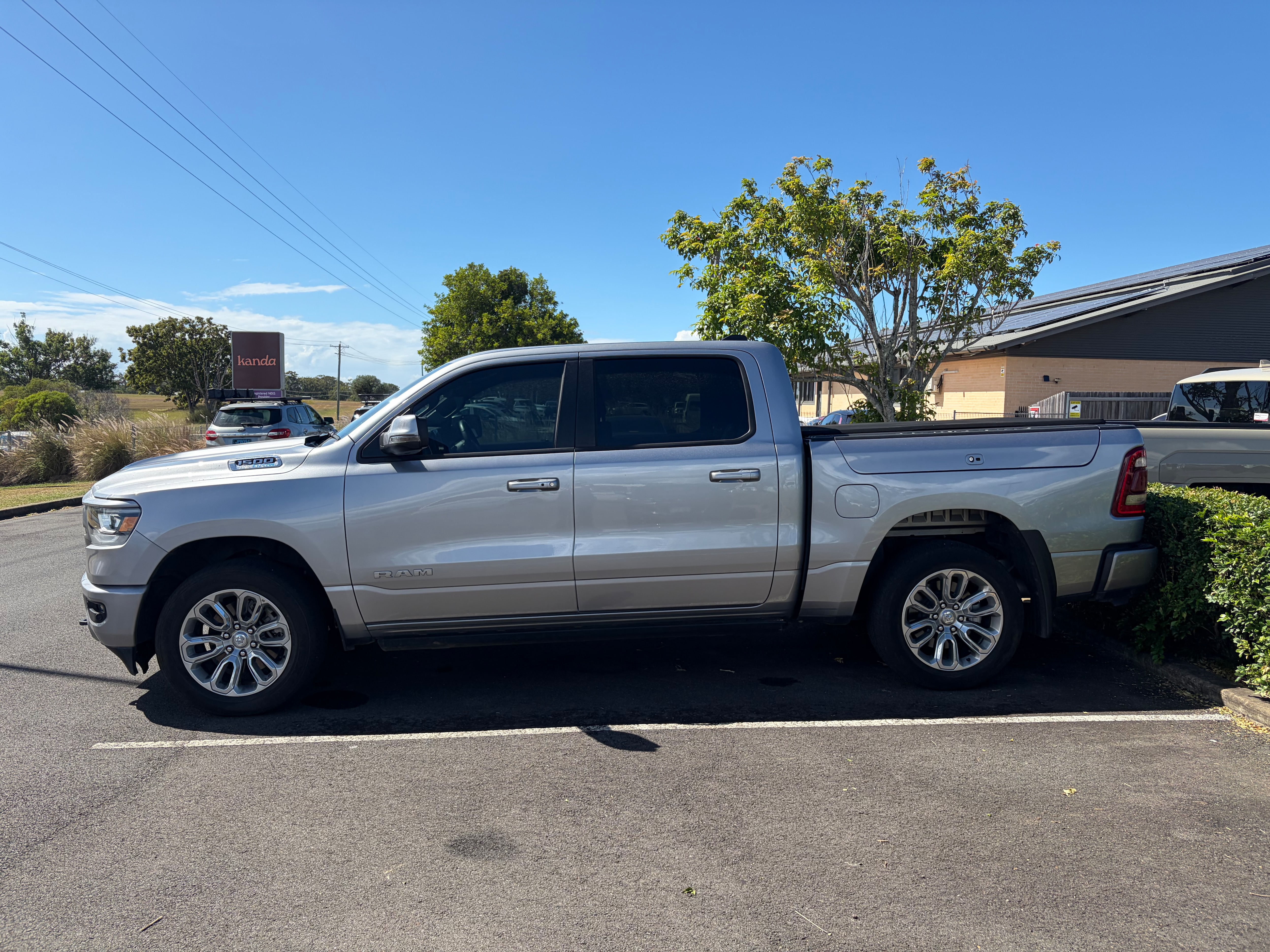 A big silver ute parked in a car park