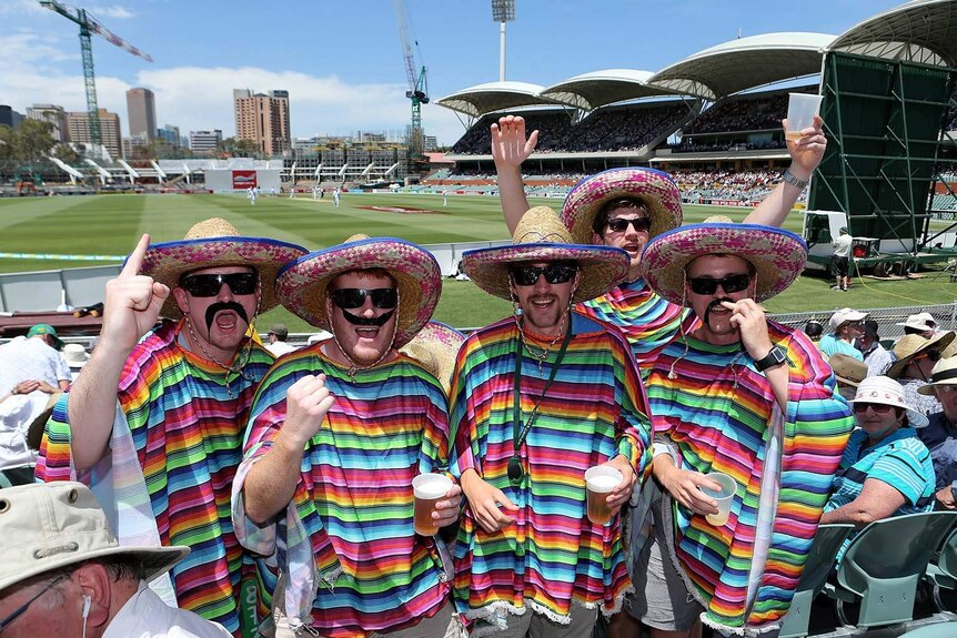Some colourful fans enjoy the action on day two.
