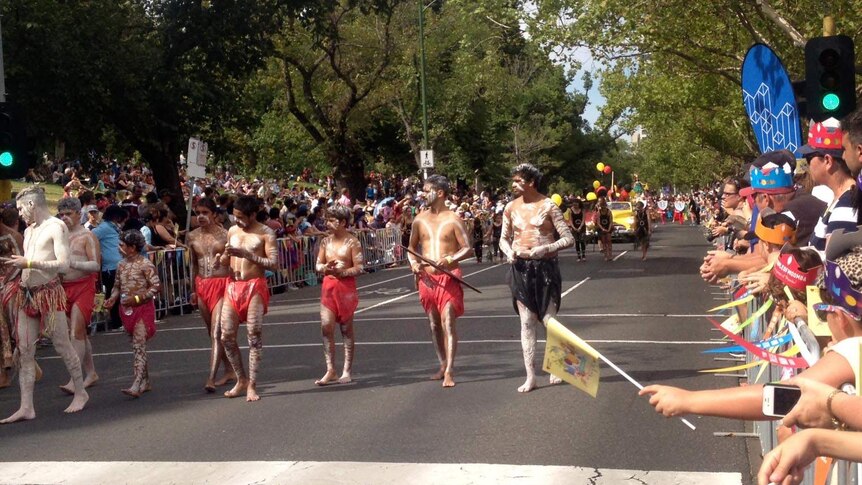 Spectators line St Kilda Road to watch the Moomba Parade in Melbourne.