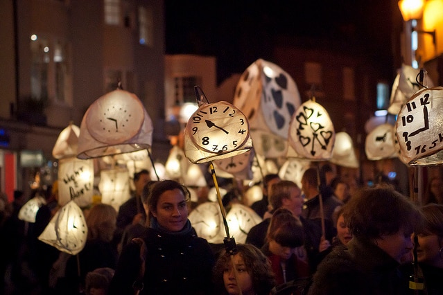 People attending the Burning of the Clocks festival at night in Brighton, England