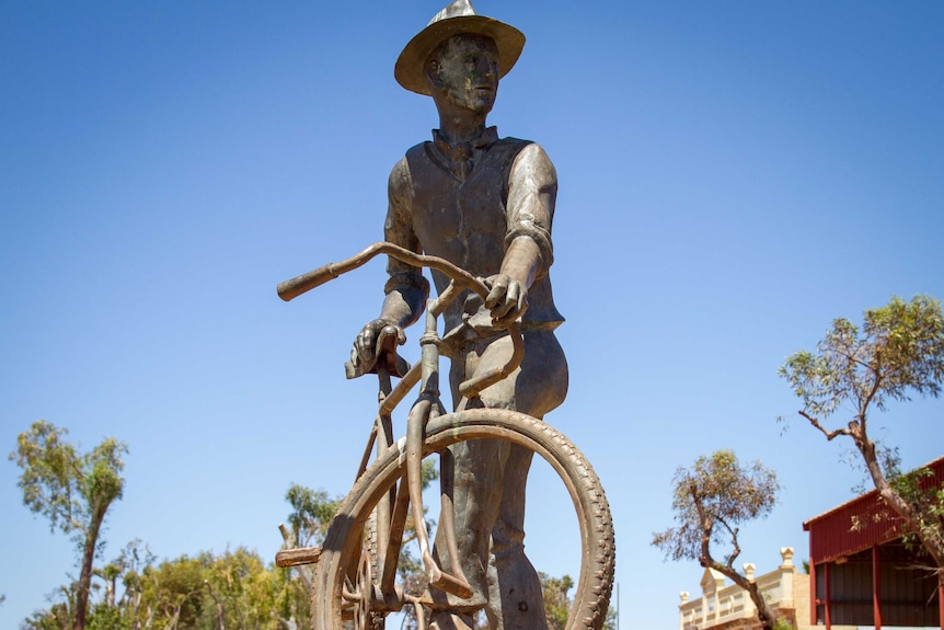 A statue of Dr Charles Laver and his bike in Laverton.