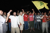 Lebanese people cheer the speech of Hezbollah chief Hassan Nasrallah.