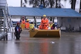 people in a rescue boat wearing life jackets