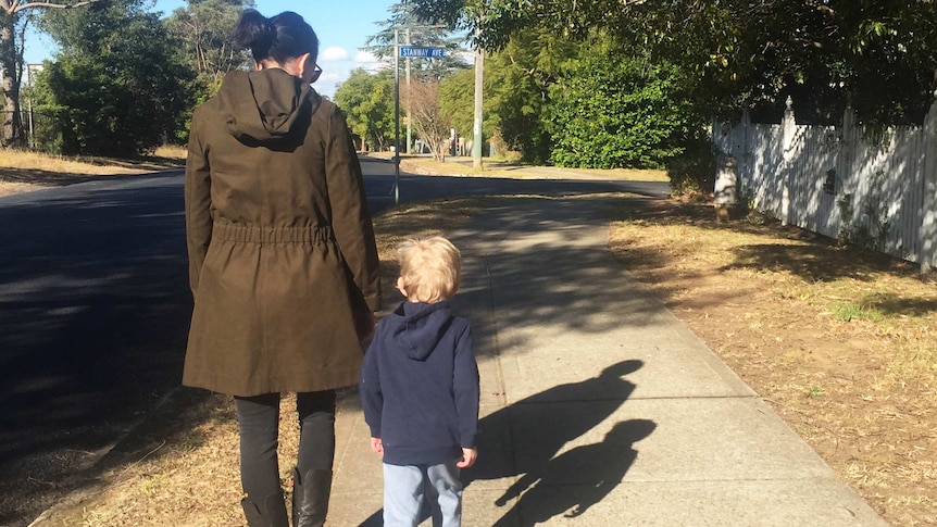 Kate Dorrell walking along a path with her son Oliver in a story about helping kids accept their peers who have disabilities.