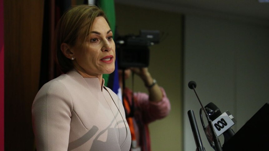 Queensland Treasurer Jackie Trad hands speaks at a podium handing down her first state budget.