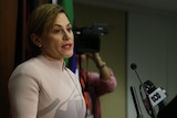 Queensland Treasurer Jackie Trad hands speaks at a podium handing down her first state budget.