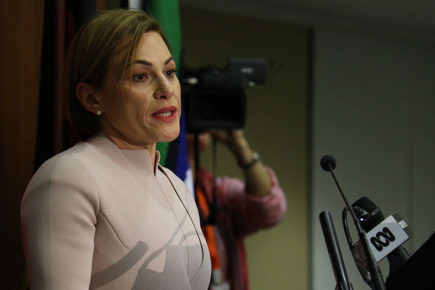 Queensland Treasurer Jackie Trad hands speaks at a podium handing down her first state budget.