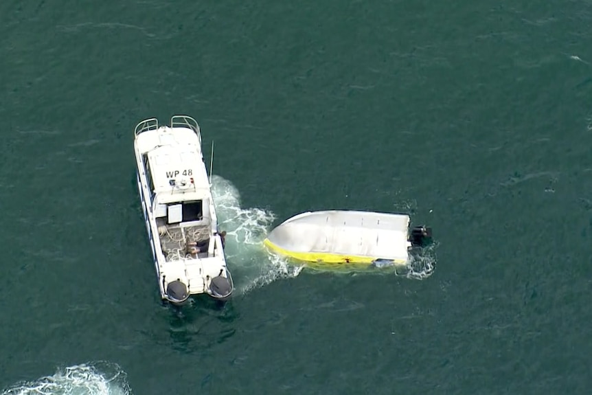 an overturned boat in the ocean