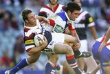 Roosters hooker Stuart Webb is tackled by opposite number Danny Buderus