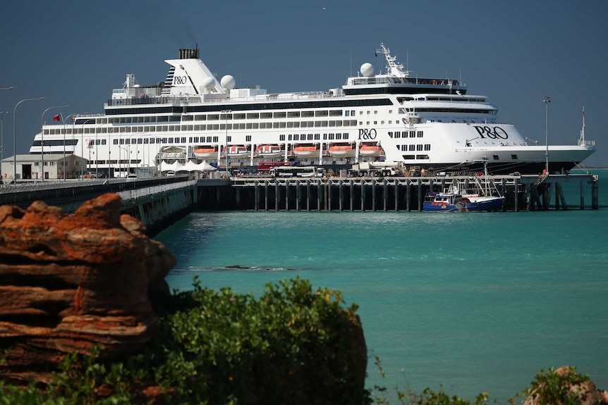 A large P&O Ocean cruiser docked at a long wooden jetty