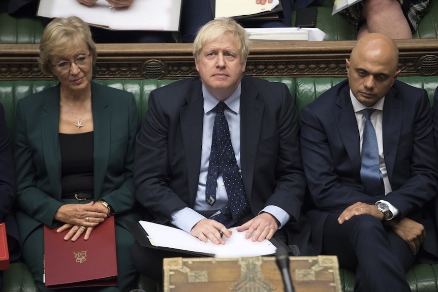 Boris Johnson is looking up as he sits in between Andrea Leadsom and Sajid Javid  in the house of commons