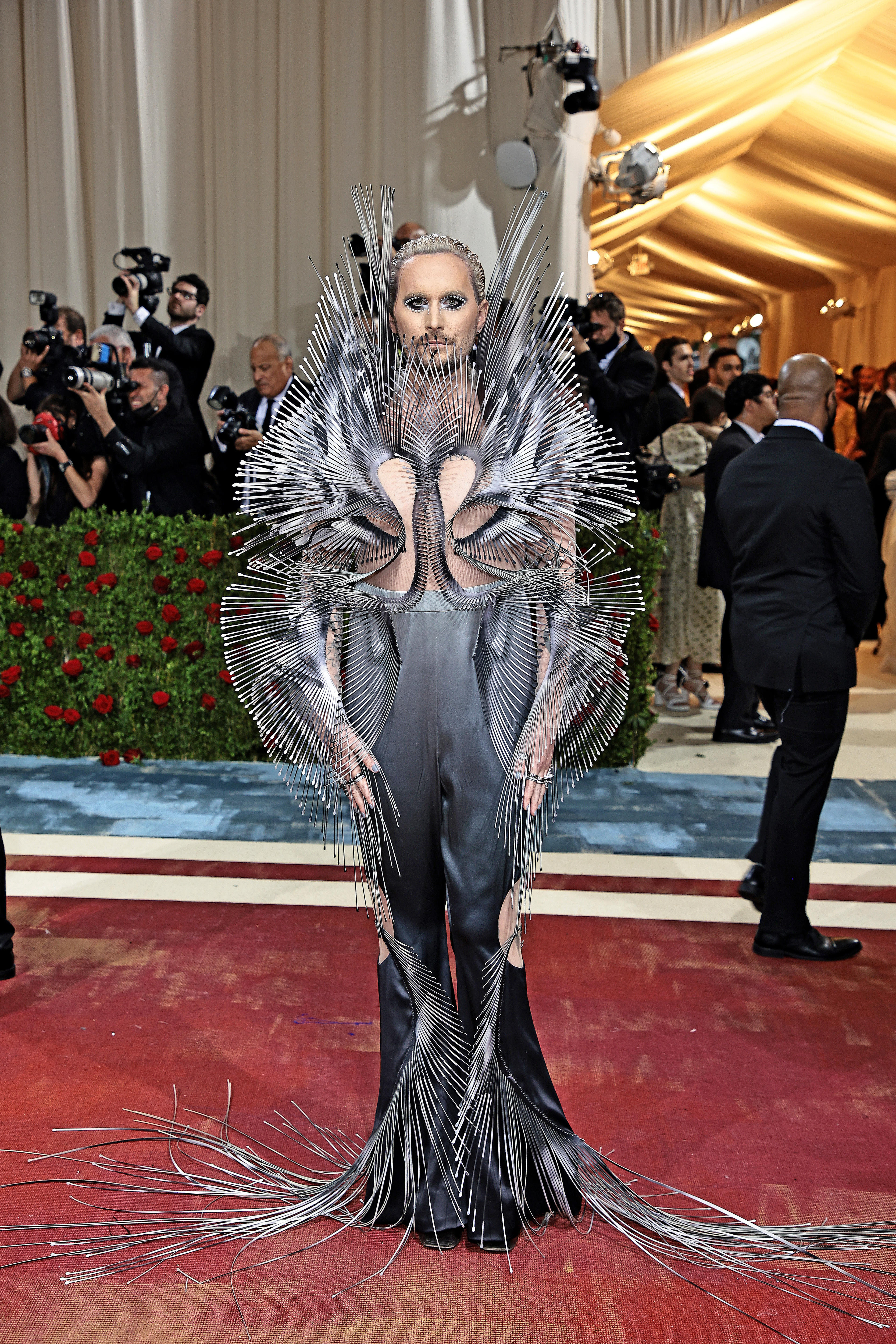 Fredrik Robertsson wears a metallic spiky costume with spines coming from his shoulders, arms and fingers on the met gala