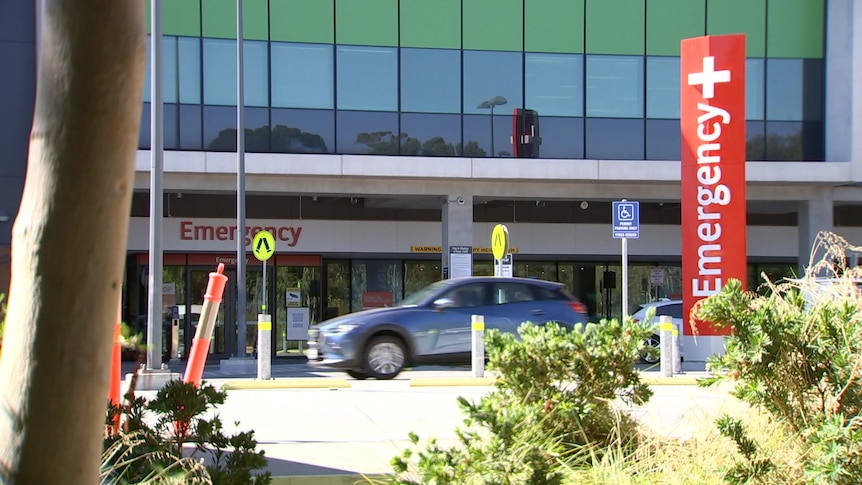 A car drives past an emergency department building