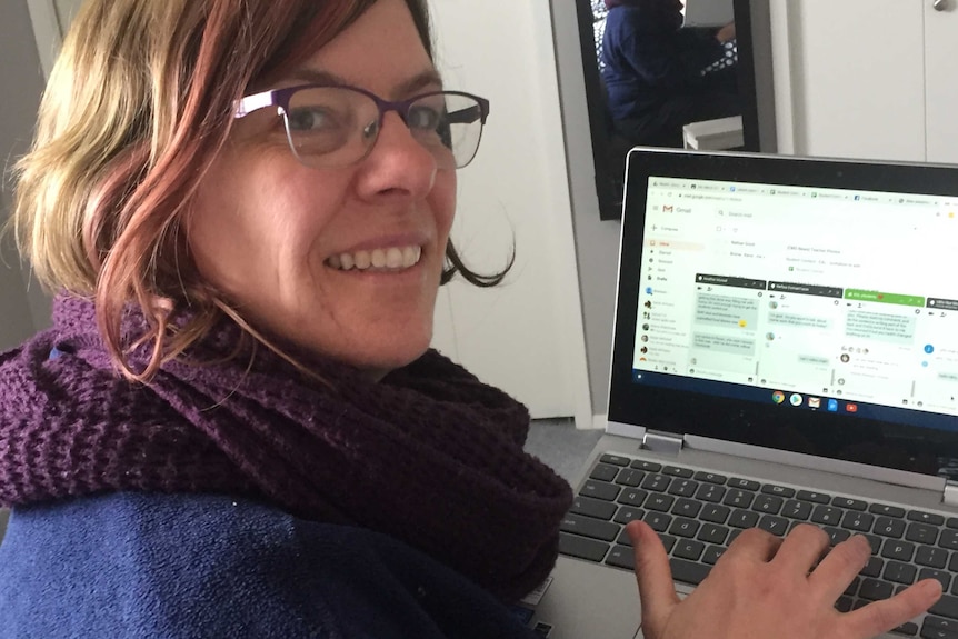 Bronwen McClelland looks to the camera as she sits in front of a laptop with Gmail open. She smiles.