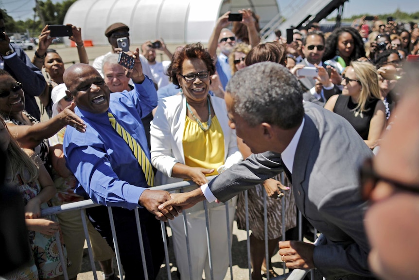US president Barack Obama shakes hands with a local resident in New Orleans