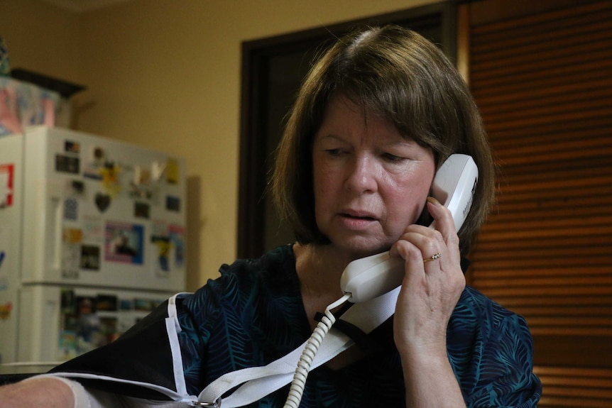 Christine O'Reilly speaks into her CapTel phone.