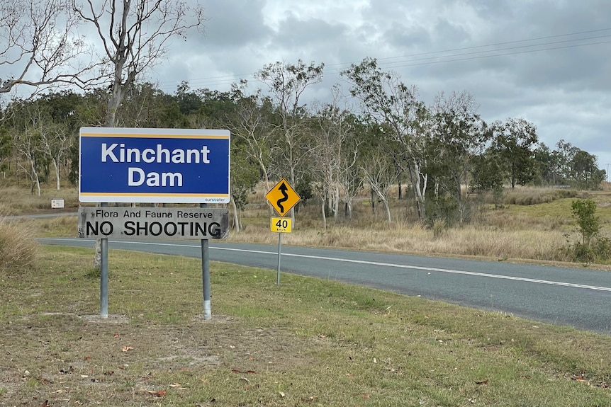 a sign on the side of the road that says Kinchant Dam
