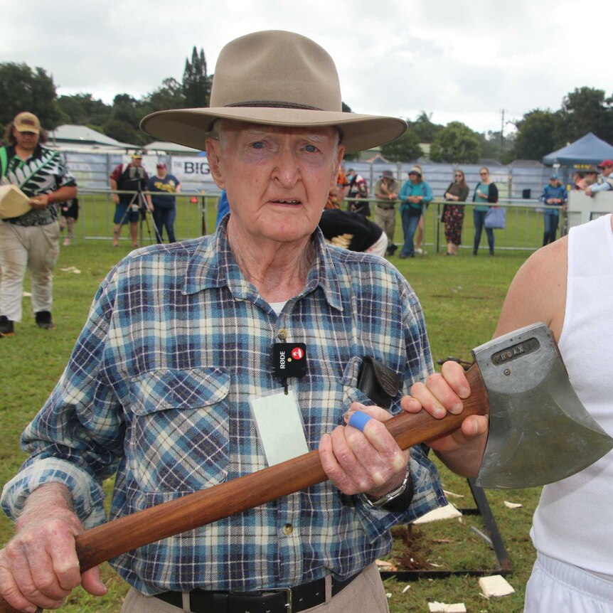 90 year old Martin Conole standing besides Nick Dunell as they both hold an axe