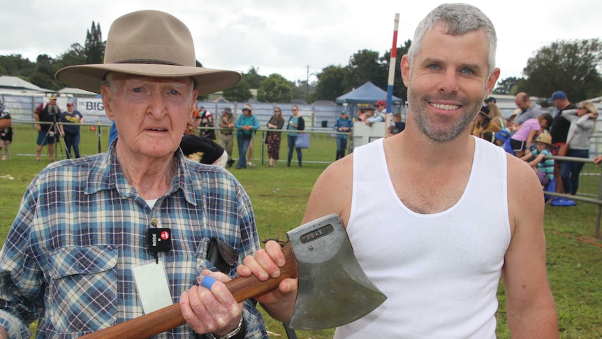 90 year old Martin Conole standing besides Nick Dunell as they both hold an axe