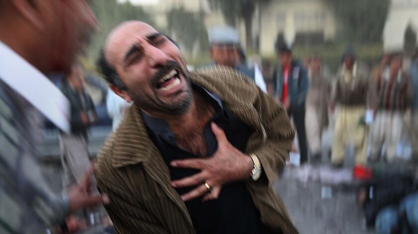 A survivor grieves at the site of the assassination of former Pakistani prime minister Benazir Bhutto