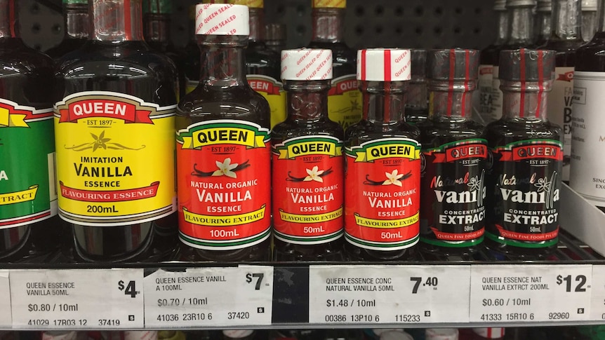 Supermarket shelves stacked with vanilla essence