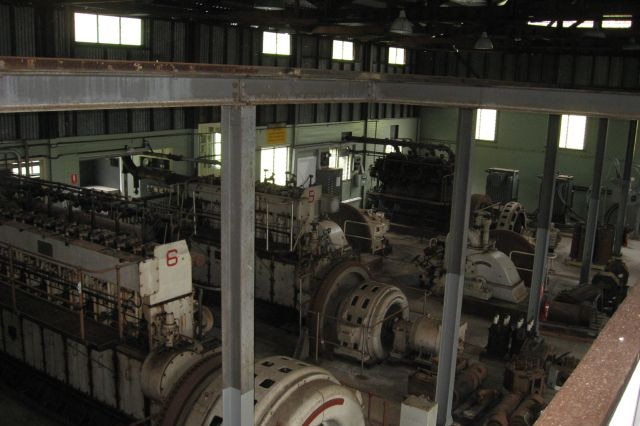 View of power station floor showing later diesel generators with original hydro turbines to rear