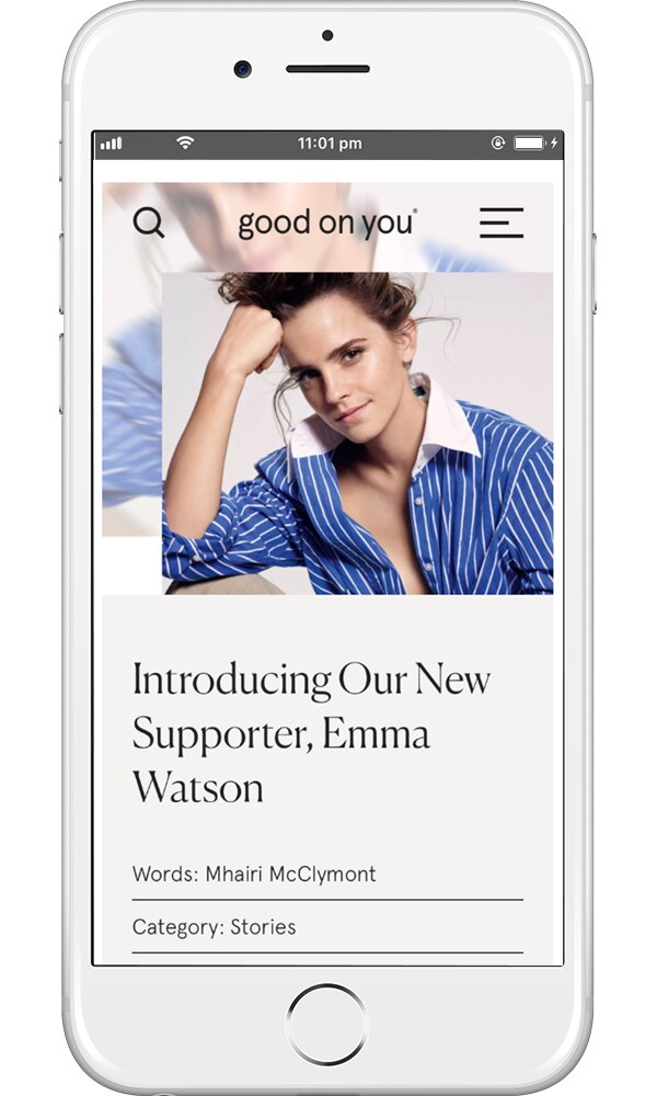 Emma Watson wearing a blue collared, striped, shirt,