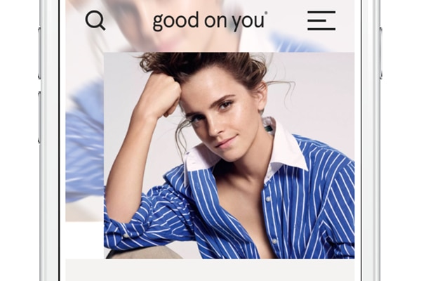 Emma Watson wearing a blue collared, striped, shirt,