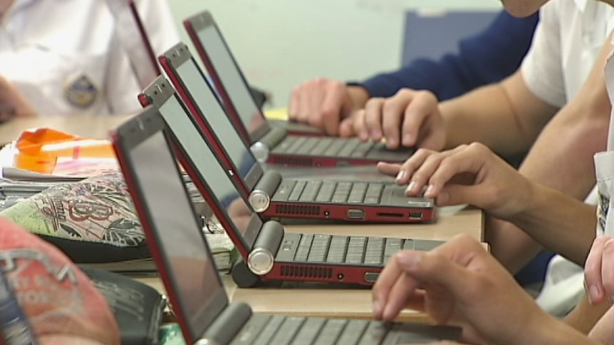 School students browse the internet on laptops