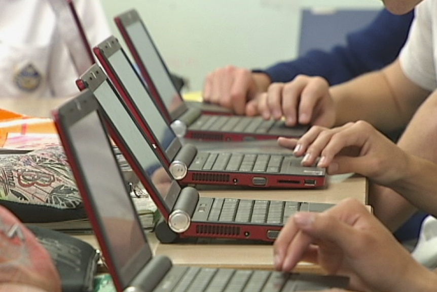 Unidentified school students use laptops