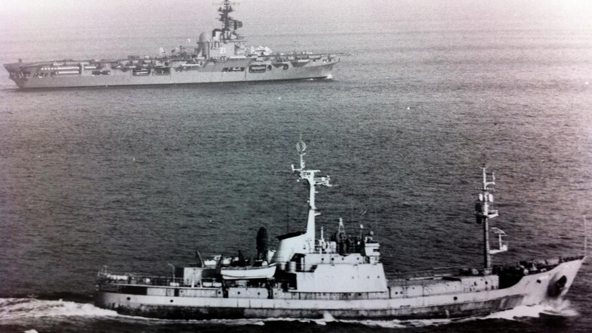 A Soviet intelligence trawler (foreground) tracks HMAS Melbourne.