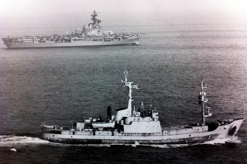 A Soviet intelligence trawler (foreground) tracks HMAS Melbourne.
