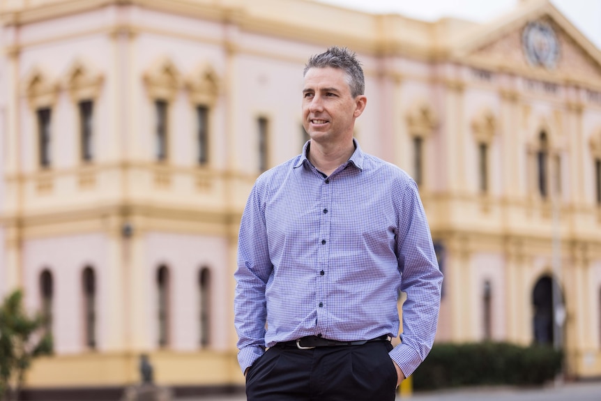 A man, Glenn Wilson, with his hand in his pockets in front of the Kalgoorlie Town Hall during mayoral election.  