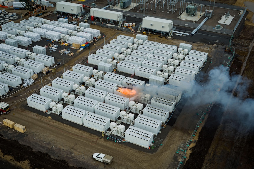 An aerial photo showing large white battery on fire.