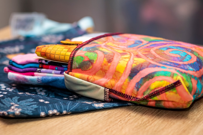 A colourful pouch filled with reusable pads.