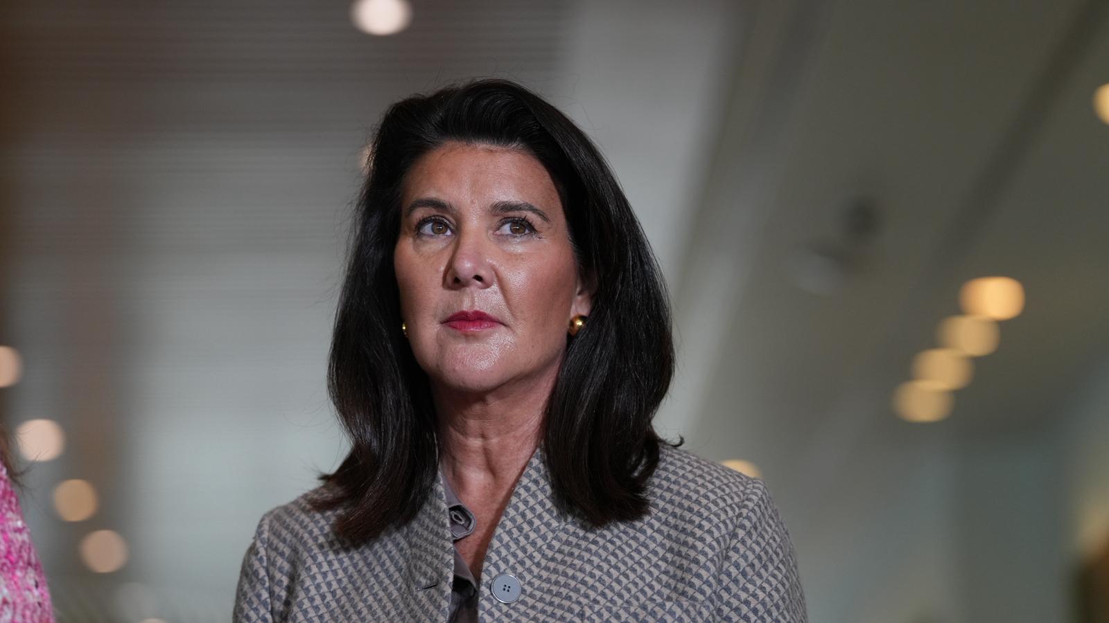 Liberal senator Jane Hume looks pensive at a press conference.