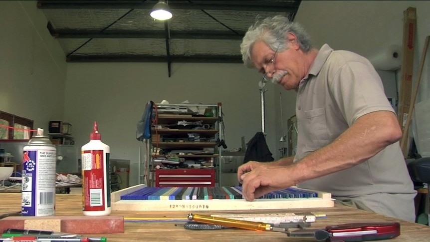 Klaus Moje preparing strips of glass which will be fused as the first stage of his process