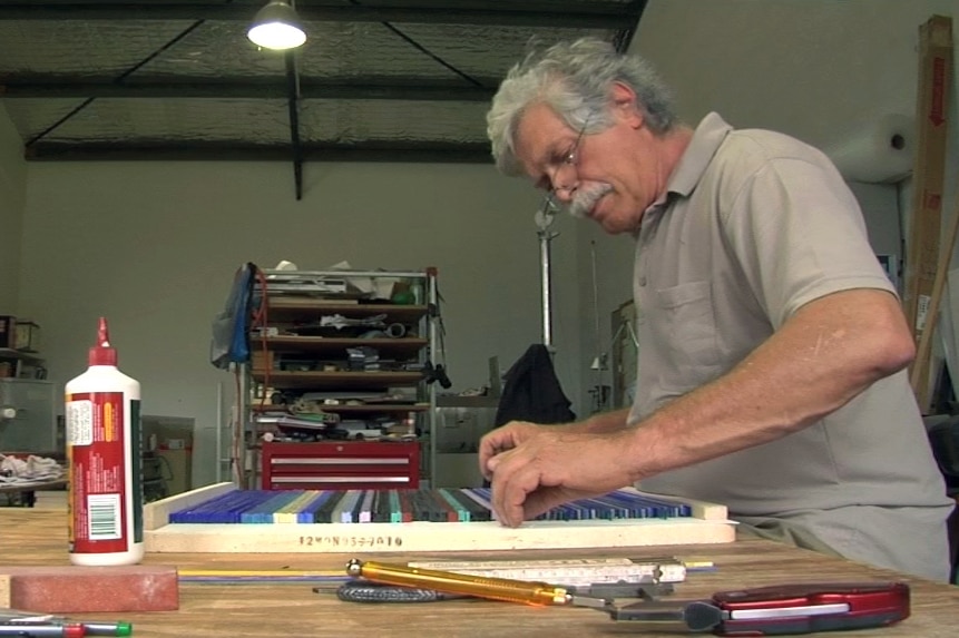 Klaus Moje preparing strips of glass which will be fused as the first stage of his process