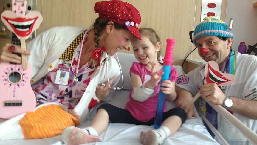 Clown doctors joke with Miley Joseph, 3, after she was transferred to Gold Coast University Hospital.