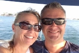 John and Yvette Nikolic on a boat, smiling for the camera.