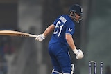 England batter Jonny Bairstow looks back at his stumps as India bowler Mohammed Shami celebrates.