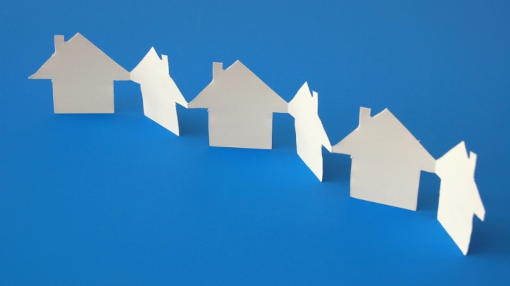 White paper houses on blue background