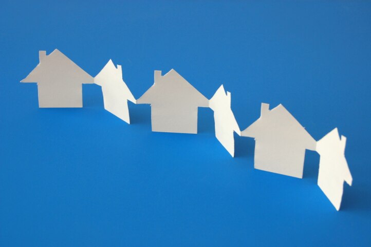 White paper houses on blue background