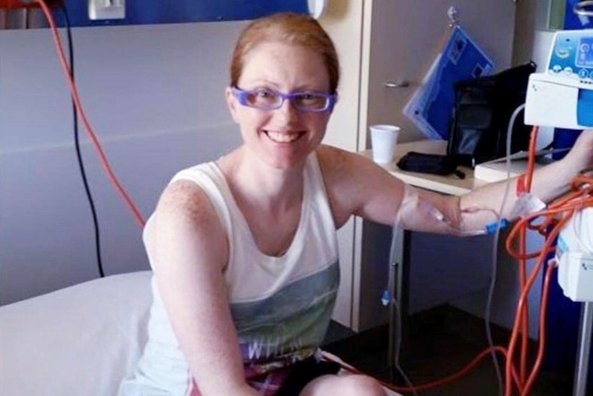 Woman sitting on hospital bed waiting for pancreas transplant operation