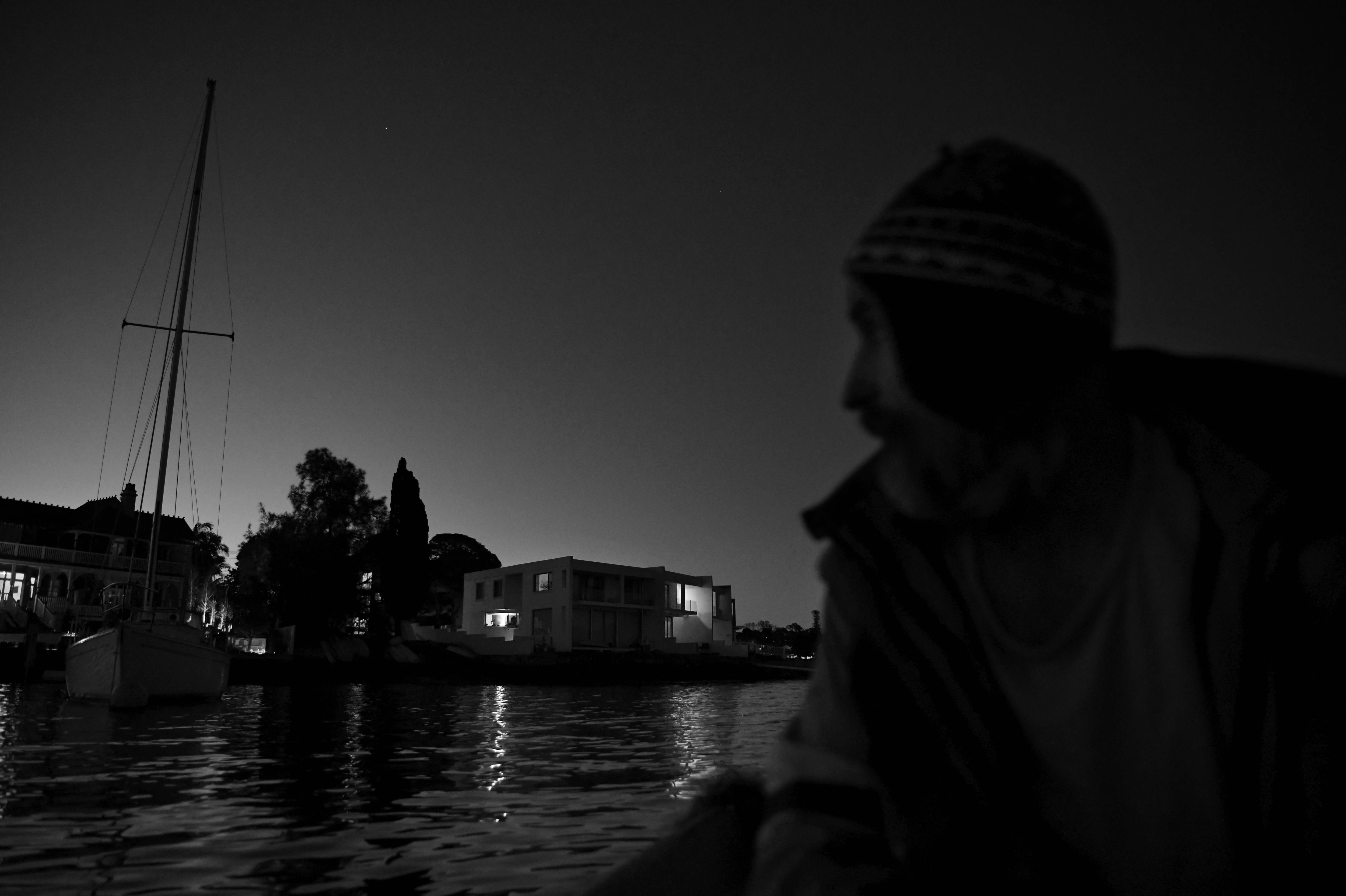 A man silloutted in side profile in the dark