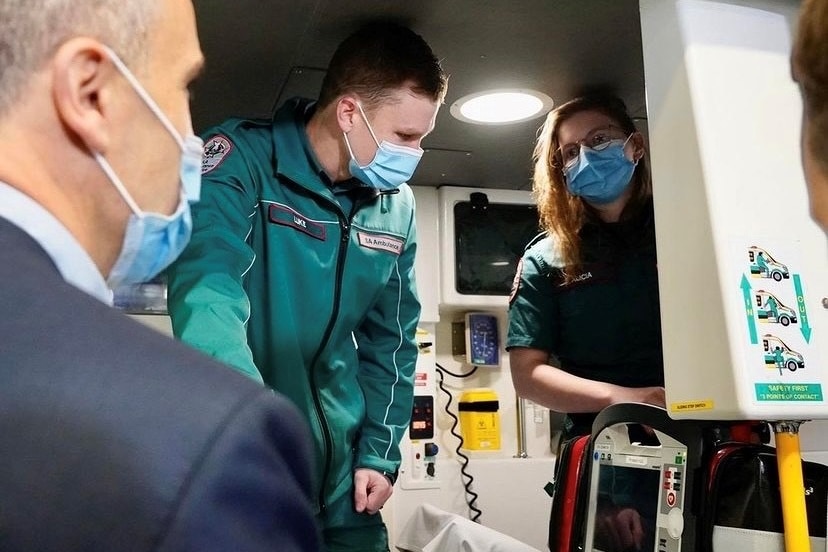 Two paramedics looking out from an ambulance 